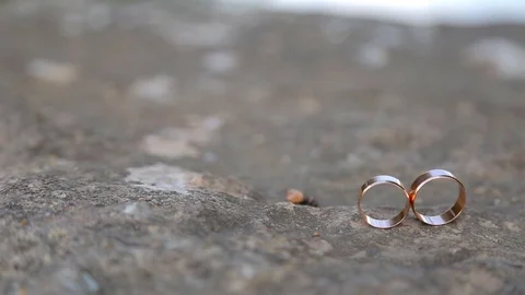 Gold ring lie on the stone surface Vidéo 123780362