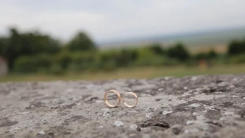 Gold ring lie on the stone surface in sunny day Stockbeeldmateriaal 123782073