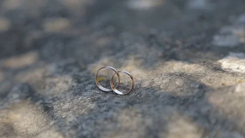 Gold ring lie on the stone surface in sunny day Stockbeeldmateriaal 123898170