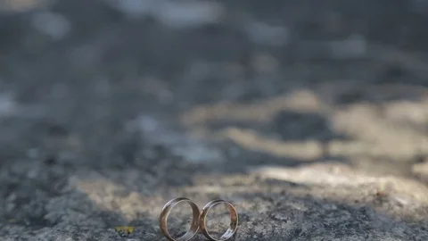 Gold ring lie on the stone surface in sunny day Stockbeeldmateriaal 123898257