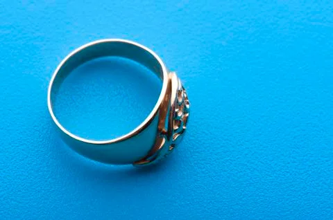 Gold ring macro on blue Stock Photos