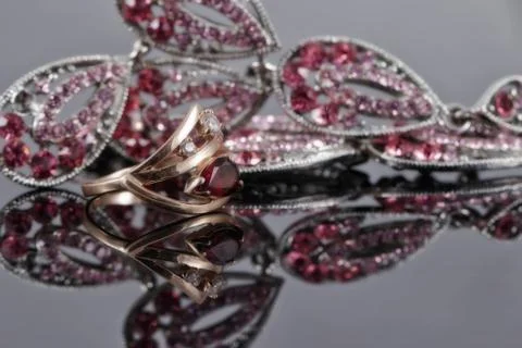 Gold ring with a ruby in the background of fashion jewelry 스톡 사진
