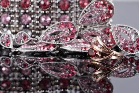 Gold ring with a ruby in the background of fashion jewelry 스톡 사진