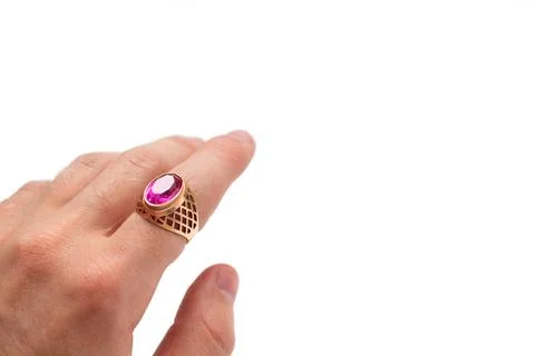A gold ring with a ruby on the finger of the hand Stock Photos
