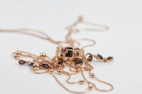 Gold ring with ruby inserts in the shape of stars and ruby earrings Stock Photos