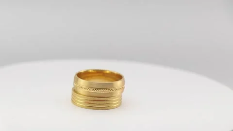 Gold rings of different designs rotating on a display stand. Real gold ring Video stock 272739858