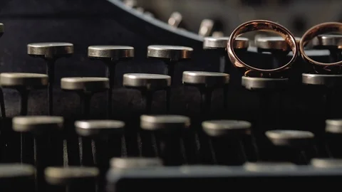 Gold Rings on the typewriter macro Wedding closeup shoot diamon Jewellery Stock Footage 114495964