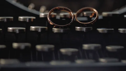 Gold Rings on the typewriter macro Wedding closeup shoot diamon Jewellery 스톡 동영상 114496026