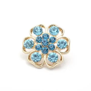 Gold round brooch with blue diamonds isolated on white Foto stock