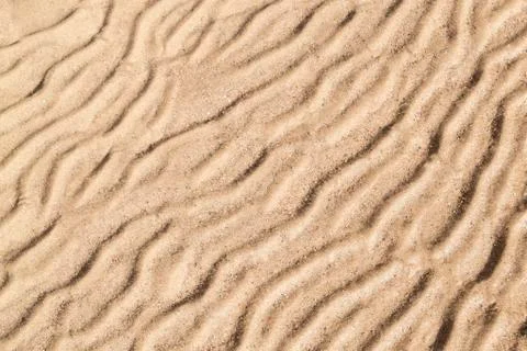 Gold sand with abstract wave pattern. Sand texture background. Summer  and ho Stock Photos