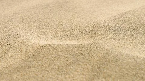 Gold sand texture background. Macro beach grit Stock Photos