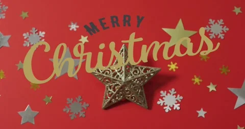Gold script entering left sweeping over star ornament on red backdrop, sliding Stock Footage 321318992