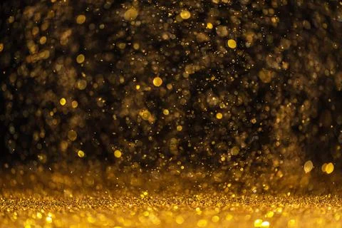 Gold sequins fall on a black background Stock Illustration