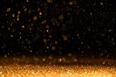 Gold sequins fall on a black background Stock Illustration