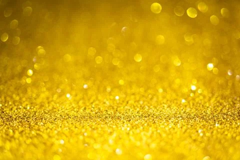 Gold shiny glitter texture. Selective focus. Glowing surface, sparkle lights  Stock Photos