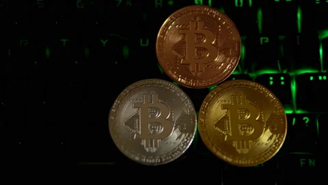 Gold, silver, bronze, bitcoin coins on the background of a flashing keyboard. 스톡 동영상 88274332