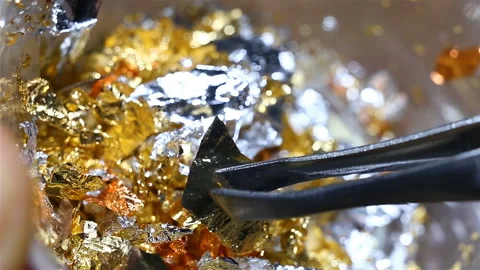Gold, silver, copper leef extremely close-up, real time, tweezers take one piece Stock Footage 149219506