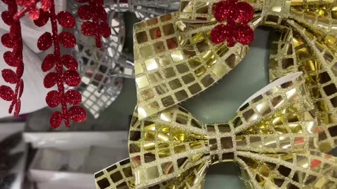 Gold sparkling sequin bows on the shelf in the store for a festive celebration. Stock Footage 325649268