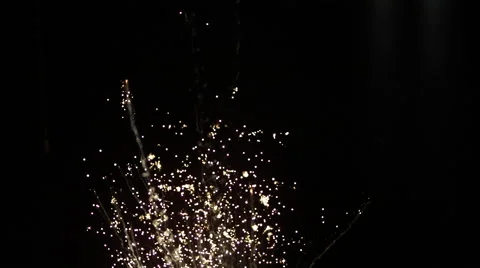 Gold sparks rising exploding over black background in slow motion Stock Footage 63788807