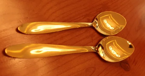 Gold Spoon on a dining table Stock Footage 329620189
