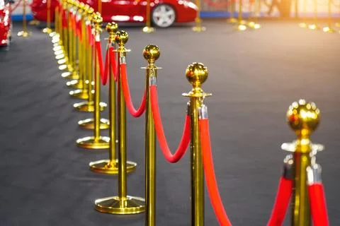 Gold support posts with red velvet textile fabric rope fencing, access cont.. Stock Photos