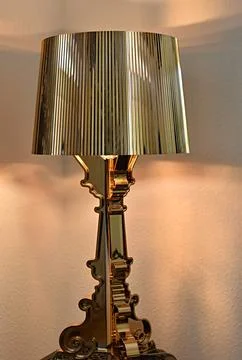 Gold table lamp on the corner Stock Photos