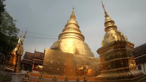 The gold temple has three towers and is surrounded by trees Stock Footage 313417161