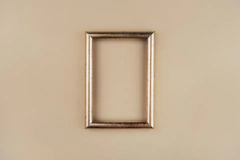 Gold text frame on a beige background. Stock Photos