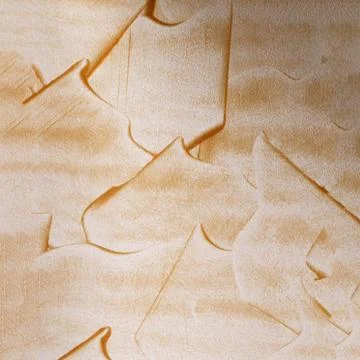 Gold texture on a white wall Stock Photos