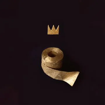 Gold toilet paper with a crown on a black background. A concept on the topic of Stock Photos