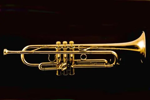 Gold trumpet isolated on black background Stock Photos