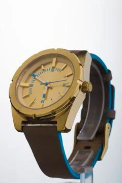 Gold watch on a plastic background Stock Photos