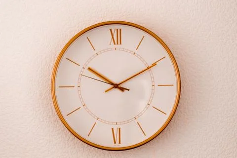 Gold watch on the wall Stock Photos