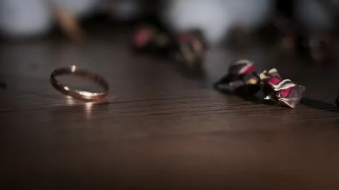 Gold Wedding Ring Falls on the Table in Slow Motion Stock Footage 255579253