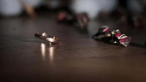 Gold Wedding Ring Falls on the Table in Slow Motion Stock Footage 260482130