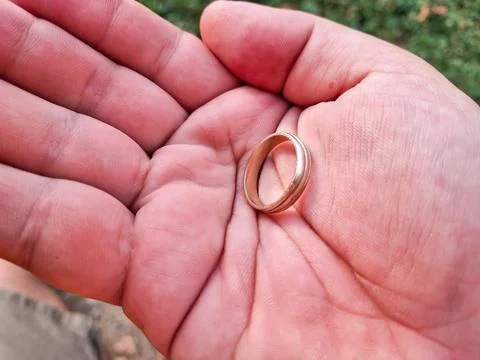 Gold wedding ring in a palm Photos