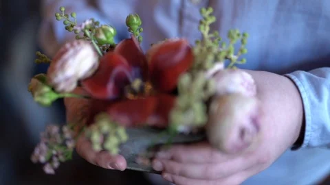 Gold wedding rings are inserted inside a beautiful red flower. Video stock 99039701