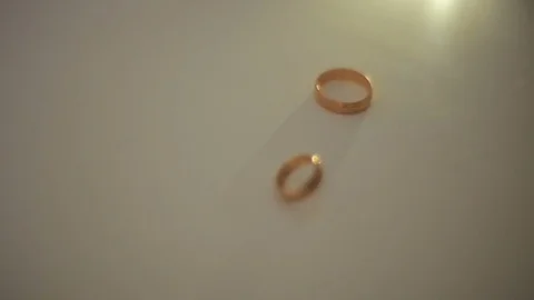 Gold wedding rings on a light background. Stock Footage 80419480