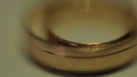 Gold wedding rings on a light background. dream of many girls and women. Wedding Stock Footage 80480727