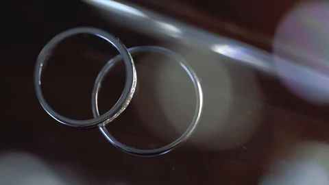 Gold Wedding Rings macro closeup lensflare shoot diamon Jewellery Stock Footage 114486249