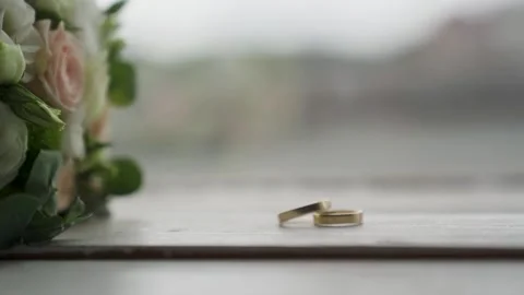 Gold wedding rings move towards each other and form an infinity sign and falling Stock Footage 221017641