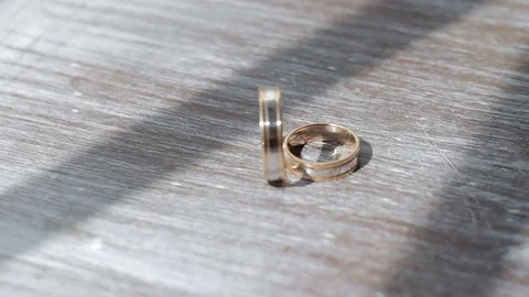 Gold wedding rings on a table close-up Stock Footage 73290714
