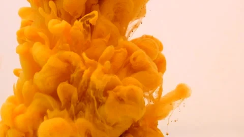 Gold yellow paint explodes and sprays in the water on a white background Stock Footage 154374650
