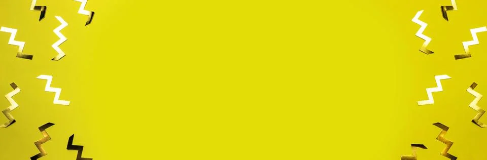 Gold zig zag shaped confetti on yellow background. Festive backdrop or banner Stock Photos