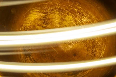 Golden abstract background with dynamic light trails and textured surface Фото