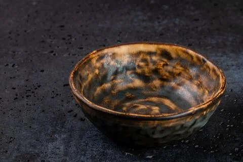 Golden abstract pattern on surface of handmade ceramic dish that is similar o Stock Photos