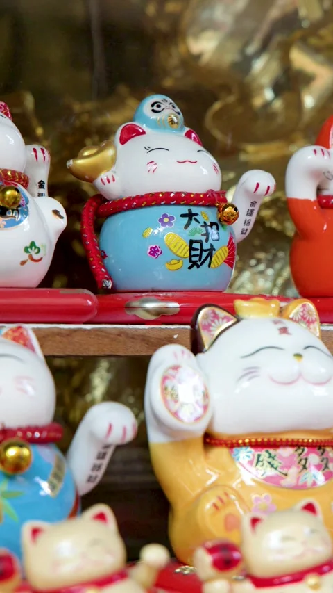 Golden and Ceramic Maneki Neko Lucky Cat Figurines in Binondo Chinatown Stock Footage 330701341