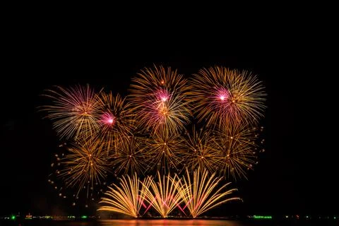 Golden And Pink Fireworks Exploding Against Deep Night Sky Wide Shot Stock Photos