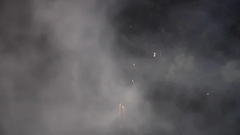 Golden and Purple Fireworks Exploding Across Smoky Night Sky 库存影片 345835071