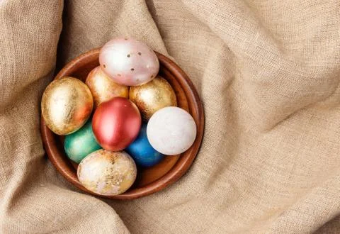 Golden and red Easter eggs in wooden plate Stock Photos